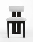 Chair with black frame and white cushioned seat and backrest on a white background