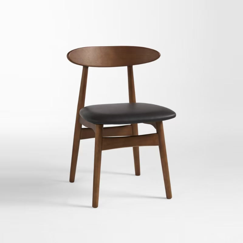 A dining chair with a solid rubber wood frame and a seat upholstered in faux leather, with a circular backrest.