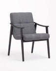 A gray upholstered dining chair with armrest and solid ash wood frame.