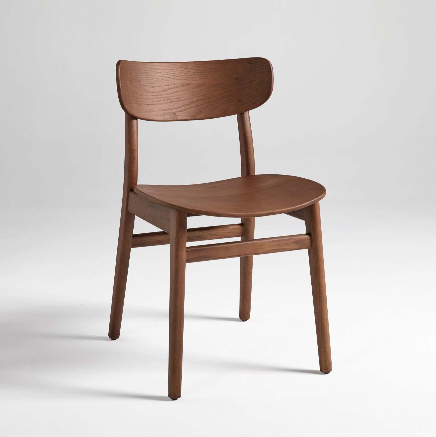 A brown dining chair made of solid ash wood, with a full backrest and seat.