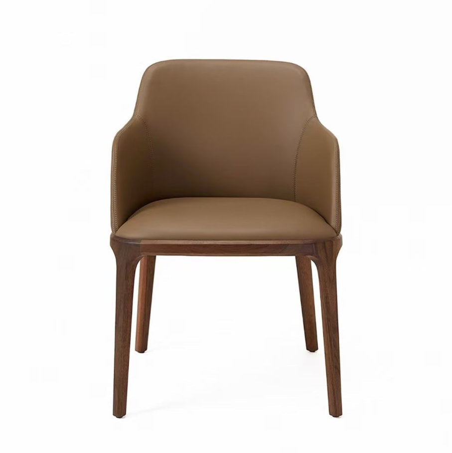 A brown dining chair with a faux leather upholstery and solid ash wood frame.