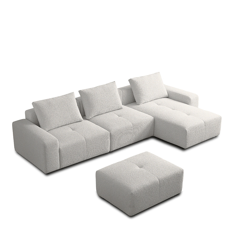 Cream white sectional sofa with ottoman on a white background